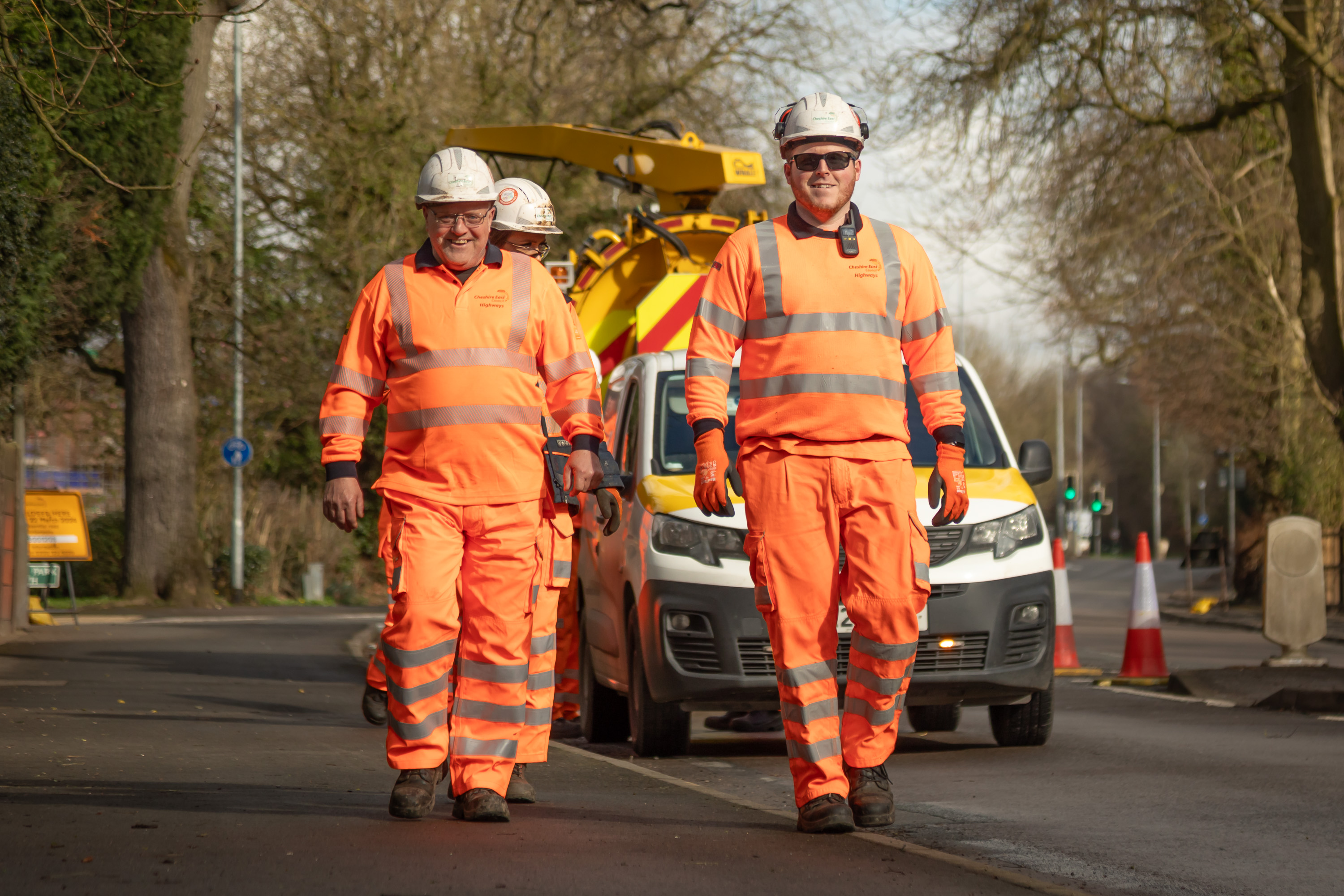 Ringway Jacobs highways operatives walking along pavement with maintenance vehicle behind, demonstrating safe and reliable service delivery