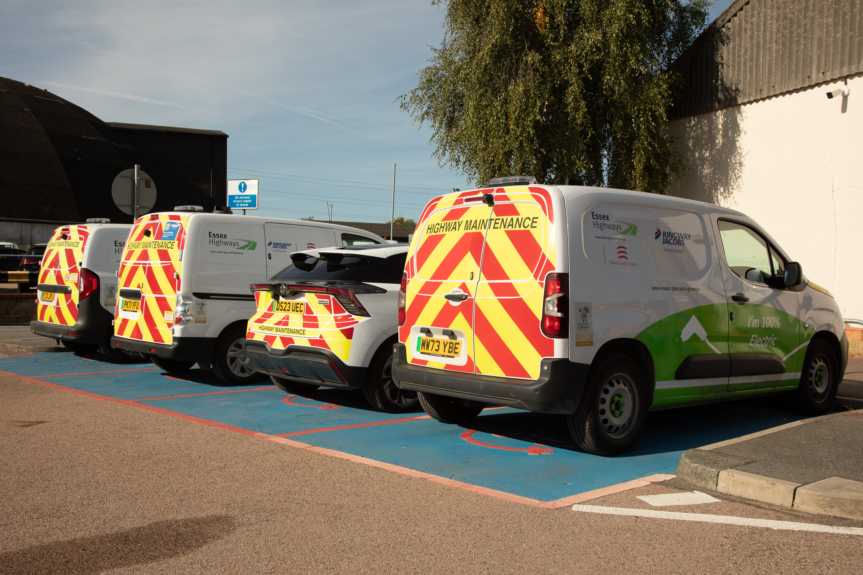 Electric service vans operated by Ringway Jacobs parked in marked electric vehicle bays, supporting carbon reduction through the use of a lower-emission fleet.